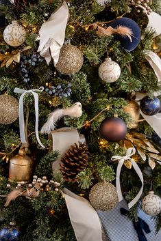 a christmas tree decorated with ornaments and ribbons