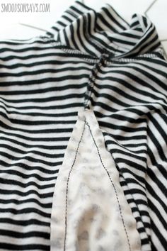 the back of a black and white striped shirt that has been sewn with scissors