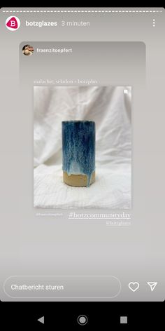 a blue vase sitting on top of a table