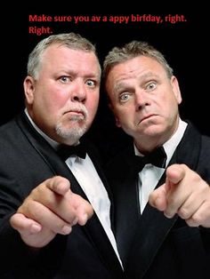 two men in tuxedos pointing their fingers at the camera