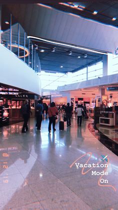 people are walking through an airport terminal