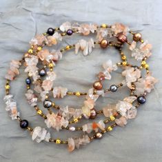 The semi precious peach quartz nuggets that I have used in this bohemian necklace range in color from clear to cream to light peach. In combination with multicolor pearls, small filigree gold tone accents, and silver lined buggle beads, they create a striking Wabi Sabi ("beautiful imperfection") effect.  This gemstone necklace is extra long, 50 inches (126 cm).  You can wear it as one very long strand, flapper-style, double wrap, or even triple wrap it for an especially rich layered look. It would make a great special occasion accessory, or a bridal necklace for a  boho chic wedding. Pearl is a June birthstone Many more extra long multi wrap necklaces are here: https://www.etsy.com/shop/ALFAdesigns?section_id=12558581 To see all artisan ALFAdesigns jewelry, please visit  https://www.etsy.c Bohemian Rose Quartz Beaded Necklaces, Bohemian Rose Quartz Beaded Necklace With Gemstones, Bohemian Rose Quartz Gemstone Beaded Necklace, Bohemian Rose Quartz Gemstone Necklace, Bohemian Beaded Necklace With Rose Quartz, Handmade Bohemian Rose Quartz Beaded Necklaces, Adjustable Bohemian Rose Quartz Beaded Necklace, Handmade Bohemian Rose Quartz Beaded Necklace, Bohemian Orange Crystal Necklace With Natural Stones