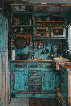 an old fashioned kitchen with blue painted cabinets