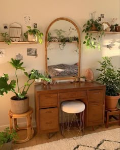 a room with plants and a mirror on the wall