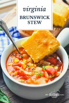 a white bowl filled with stew and cornbread on top of a wooden cutting board