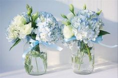 two vases with blue and white flowers in them