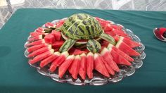 a turtle made out of watermelon slices on top of a glass platter