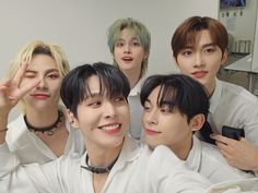 the group of young men are posing together for a photo in front of a mirror