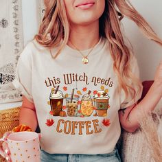 Looking for the perfect fall shirt to show off your love for coffee and all things spooky? Look no further than our "This Witch Needs Coffee" t-shirt! With a playful design, this pumpkin shirt is perfect for coffee lovers and Halloween enthusiasts alike. Whether you're enjoying a crisp autumn morning or getting into the Halloween spirit, this shirt is sure to be a hit. So grab your favorite mug and get ready to brew up some fun in our "This Witch Needs Coffee" t-shirt! This classic unisex jersey Relaxed Fit Coffee Color Tops For Fall, Coffee Colored Tops With Letter Print For Fall, Coffee Letter Print Tops For Fall, Funny Graphic Print Shirt For Fall, Funny Custom Print Tops For Fall, Fall Season Relaxed Fit Shirt With Custom Print, Fall Custom Print Shirt With Relaxed Fit, Fall Relaxed Fit Shirt With Custom Print, Relaxed Fit Shirt With Custom Print For Fall