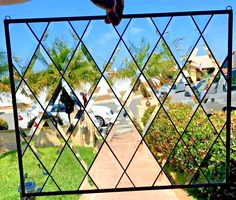 a window with a view of cars parked in the driveway