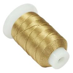 spooling thread with gold foil on white background