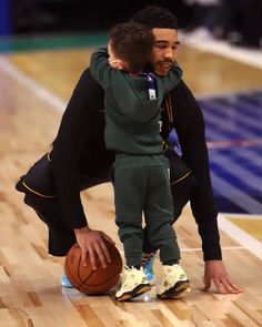 two basketball players hugging each other on the court