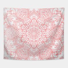 a pink and white wall hanging tapestry with an intricate flower design on the bottom corner