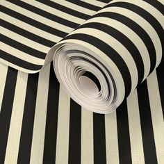 a black and white striped wallpaper with vertical stripes on the bottom half of it