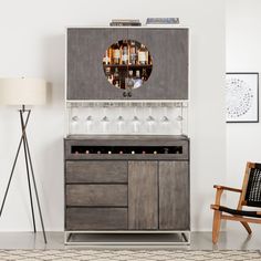 a room with a chair, table and wine glass rack on the wall next to it