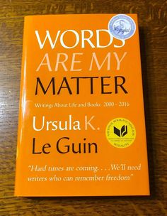 the book words are my matter by ursula k le guin on a wooden table