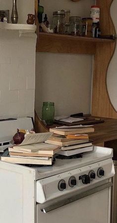 an old stove with many books on it