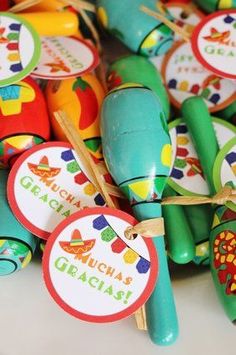 a bunch of colorful wooden spoons sitting next to each other on top of a table