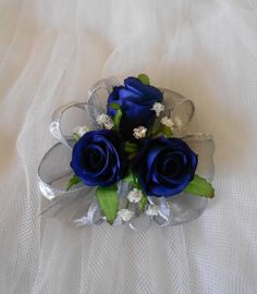 a bouquet of blue roses on a white sheet