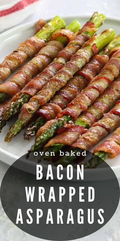 bacon wrapped asparagus on a plate with text overlay that reads oven baked bacon wrapped asparagus