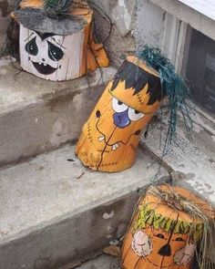 two pumpkins with faces painted on them sitting in front of a window