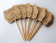 six wooden stick with love is sweet written on them, sitting next to each other