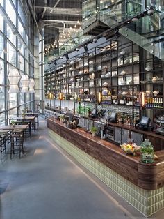 the inside of a restaurant with lots of glass walls and shelves filled with food items