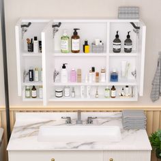 a white sink sitting under a bathroom mirror next to a shelf filled with personal care items