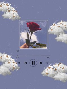 there is a red rose in the middle of some clouds