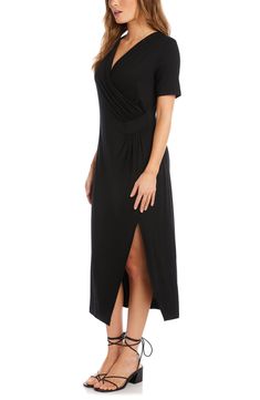 Cut from drapey jersey, this fluid midi is designed with a wrapped bodice and a stem-showing side vent. 48 1/2" length (size Medium) Surplice V-neck Short sleeves Unlined 92% rayon, 8% spandex Dry clean or hand wash, dry flat Made in the USA Bohemian Chic Outfits, Black Dress Style, Petite Midi Dress, Midi Dress Elegant, Casual Short Sleeve Dress, Asymmetrical Hem Dress, Dress With Short Sleeves, Wrap Midi Dress, Karen Kane