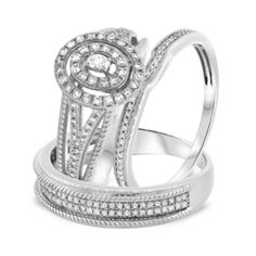 two white gold wedding rings with diamonds on each band and an oval shaped diamond in the middle