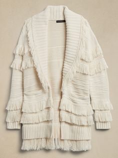 Meet the challenge of cooler temperatures with soft fringe, this luxurious cardigan is crafted from sumptuous organic cotton, knitted into tiers of raised ridges and fringed accents that dance ever-so-beautifully in the breeze.  RELAXED FIT: Expertly Chic Fringe Cardigan, Chic Long Sleeve Fringe Cardigan, Fringe Cardigan For Fall, Fringe Cardigan For Fall Layering, Spring Fringe Cardigan For Layering, Sleeveless Sweater Cardigan, White Long Sleeve Cardigan, Fringed Cardigan, Chunky Sweater Cardigan