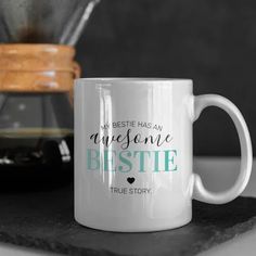 a white coffee mug sitting on top of a counter