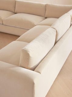 a white couch sitting on top of a hard wood floor