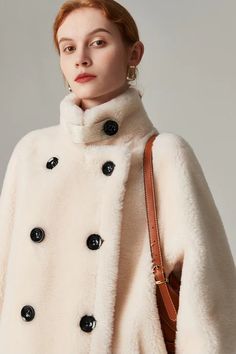 Embrace winter with our stand collar shearling coat, a blend of contemporary design and classic appeal. Luxury Outerwear With Stand Collar, Elegant Long Shearling Coat, Elegant Shearling Outerwear For Winter, Elegant Winter Shearling Outerwear, Luxury Winter Outerwear With Stand Collar, Elegant Sheepskin Outerwear For Work, Elegant Shearling Outerwear For Cold Weather, Winter White Sheepskin Outerwear, Winter White Sheepskin Outerwear For Winter