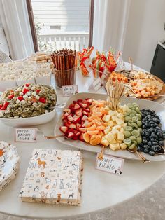 a table topped with lots of different types of food and snacks on top of plates