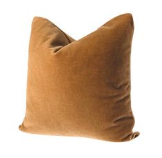 a brown pillow sitting on top of a white wall