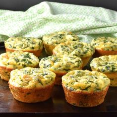 small muffins with spinach and cheese on top