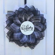 a black and white wreath with the word welcome on it