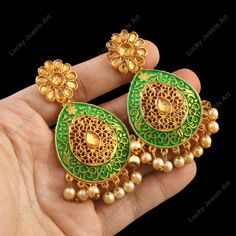 Our ears are the most eye-catching attraction of face. Earrings are the one of the major body adornment people observe when looking at you. We make your entire look stand out just by decorating your ears with our unique Kundan earrings in Indian Style. The Earrings we make is of the highest quality, both materials & craftsmanship wise. Treat yourself to it. It'll be your best friend. ❖ ❖ ❖ Features: ❖ An Indian styled dainty Kundan Chandelier Earrings. ❖ Made from fine Quality Brass with Gold Platting. ❖ Ready to be given as a gift. ❖ Easy and Convenient way to Wear. ❖ It looks prettier than the images. Direct Images on hand is also attached. Size of Earrings & Other Details: ❖ Item Code:-  ❖ Length:- 75mm approx ❖ Width:- 35mm approx ❖ Material:- Fine Quality Brass with Gold Platting ❖ Qu Ornate Jhumkas For Festivals With Pierced Ears, Green Dangle Bridal Earrings For Festivals, Green Peacock Design Earrings For Wedding, Green Earrings With Intricate Design For Festivities, Green Chandelier Earrings With Intricate Design For Festive Occasions, Green Festive Earrings With Intricate Design, Festive Green Earrings With Intricate Design, Green Bridal Earrings With Latkans For Festivals, Green Bohemian Earrings For Wedding