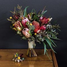 a bouquet of flowers sitting on top of a wooden table