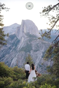 a bride and groom standing in front of a mountain with the words elopement on it