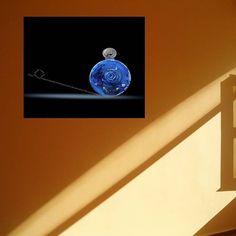 a blue vase sitting on top of a window sill next to a white wall