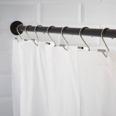 the curtain rod is attached to the white shower curtain