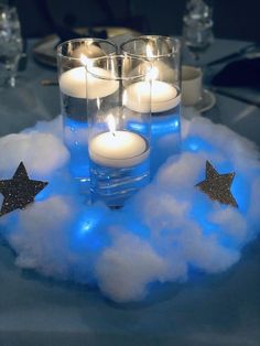 some candles are sitting in the clouds with stars