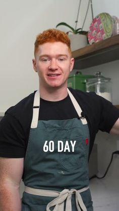 a man wearing an apron with the words 60 day written on it in front of him