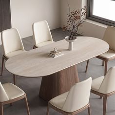 an oval dining table with white chairs around it