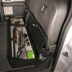 the inside of a car with tools and other items in its storage compartment on the floor