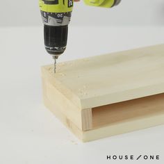 a person drilling wood with a drill