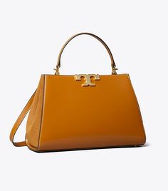 Eleanor Satchel: Women's Designer Satchels | Tory Burch Timeless Top Handle Bag For Fall, Classic Tan Satchel With Leather Handles, High-end Tan Satchel, Luxury Satchel For Fall, Formal Fall Satchel With Leather Handles, Timeless Satchel With Round Handle, Timeless Top Handle Bag, Timeless Crossbody Satchel With Gold-tone Hardware, High-end Tan Satchel With Top Carry Handle